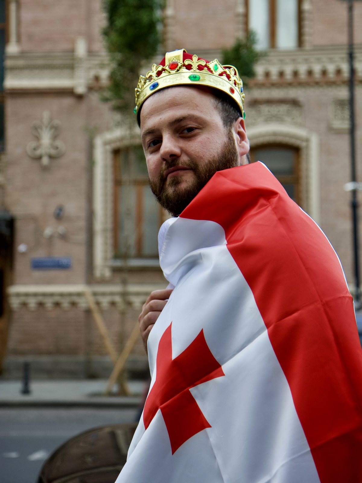 Young Georgian man in Tbilisi with the National flag of Georgia