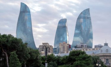 The three Flame Towers of Baku rising above the green city park, Azerbaijan