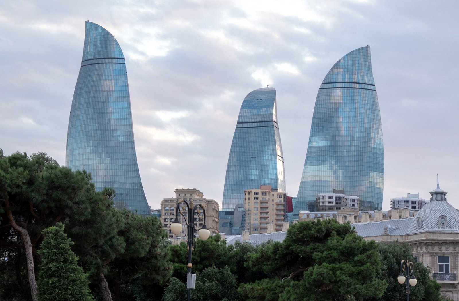 The three Flame Towers of Baku rising above the green city park, Azerbaijan
