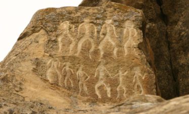 Prehistoric human figures carved into sandstone rock at the Gobustan UNESCO World Heritage Site, Azerbaijan