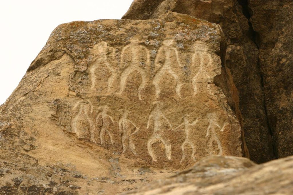 Prehistoric human figures carved into sandstone rock at the Gobustan UNESCO World Heritage Site, Azerbaijan
