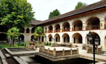 Courtyard of a historic caravanserai in Sheki with arched arcades and fountain, Silk Road, Azerbaijan