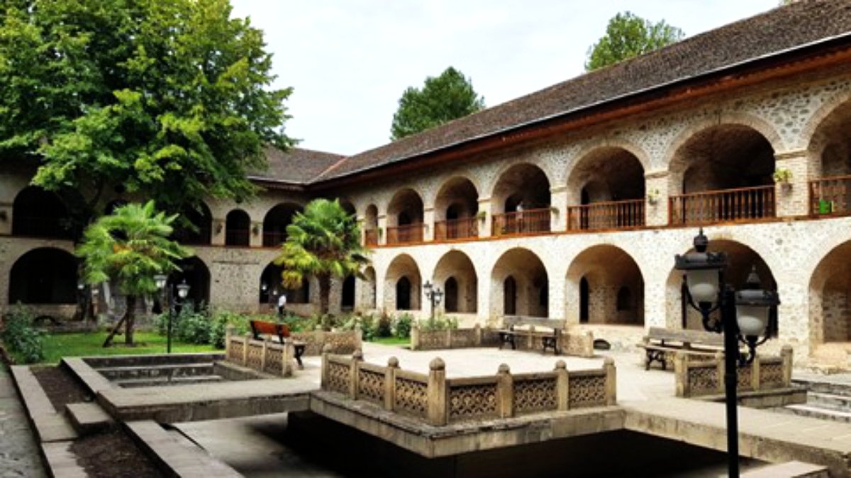 Courtyard of a historic caravanserai in Sheki with arched arcades and fountain, Silk Road, Azerbaijan